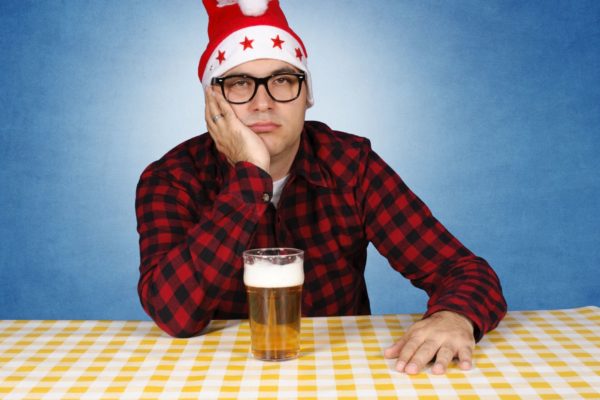 15895736 - bored santa with the beer. selective focus on the man.